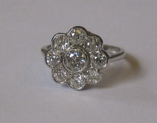 A lady's 18ct white gold cluster dress ring set a large diamond surrounded by 8 small diamonds approx 1.45ct