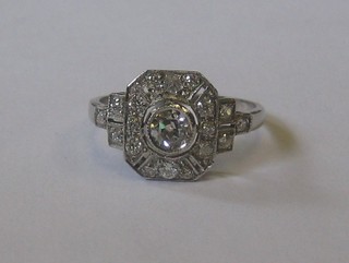 A lady's 18ct white gold dress ring set a large circular diamond supported by 9 diamonds and with 6 diamonds to the shoulders, approx 0.65ct