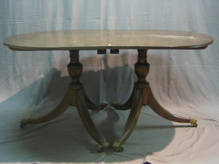 A Georgian style mahogany D end extending dining table and 3 extra leaves