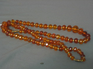 2 amber coloured necklaces