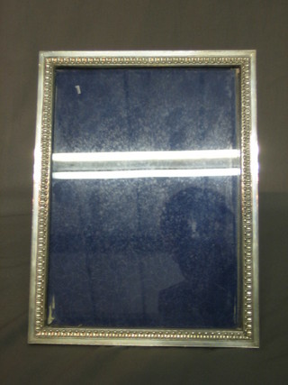 A modern silver easel photograph frame 9" x 7"