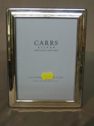A modern plain silver easel photograph frame 8" x 6"