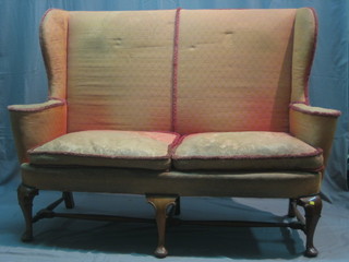 A Queen Anne style walnut wing back 2 seat settee upholstered in pink material raised on cabriole supports 65"