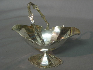 A silver boat shaped sugar bowl with cast wavy border, London 1912, 4 ozs
