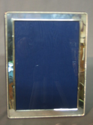 A modern silver easel photograph frame with beaded edge 8" x 6 1/2"