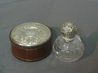 A modern cut glass dressing table jar with embossed white metal lid and a circular leather collar box with silver lid
