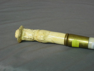 A carved ivory walking stick handle in the form of a bonnetted lady 4" on a turned shaft