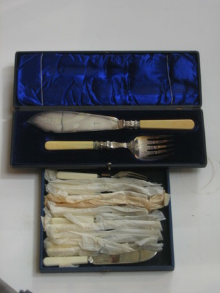 A pair of silver plated fish servers and a set of 6 silver plated fish knives and forks