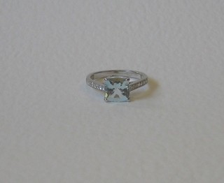 A lady's 18ct white gold dress ring set a square cut aquamarine the shoulders set numerous diamonds, approx 0.43/2ct