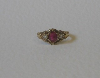 A lady's 18ct yellow gold dress ring set an oval cut ruby supported by 2 diamonds