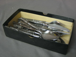 A canteen of 20 pieces of 1960's Continental stainless steel flatware comprising 5 tea spoons, 5 forks, 5 table knives and 5 spoons, marked W & H Stainless, the handles in the forms of logs