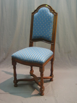 A mahogany framed Carolean style chair upholstered in blue striped material with X framed wavy stretcher