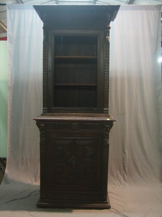 A Victorian carved oak cabinet fitted a drawer above a cupboard, heavily carved throughout 36"