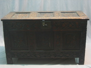 An 18th Century carved oak coffer with hinged lid and iron lock, heavily carved throughout 40"