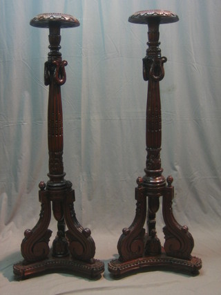 A pair of Georgian style carved and fluted mahogany torcheres