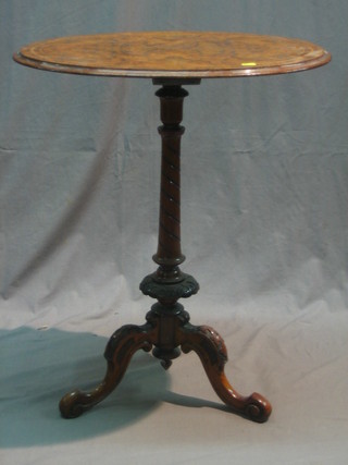 A Victorian oval figured walnut occasional table raised on a turned column and tripod base, 24"