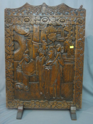 A carved Eastern hardwood firescreen decorated figures 22"