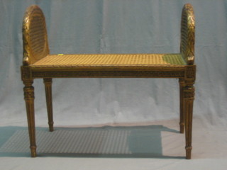 A carved gilt wood and cane window seat 27"