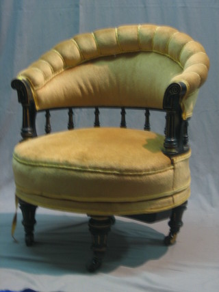 An ebony tub back chair with bobbin turned decoration, upholstered in yellow material