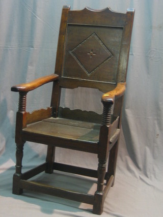 An 18th Century carved oak Wainscot chair, raised on turned and block supports