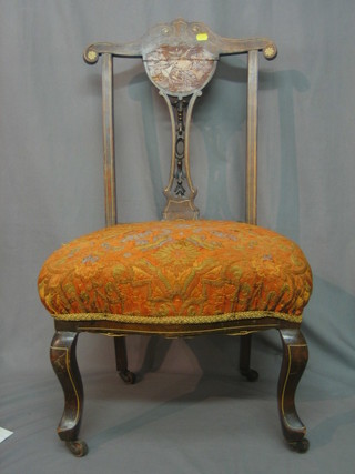 A pair of Victorian  mahogany salon chairs with vase shaped slat backs, inlaid musical trophies, raised on French cabriole supports