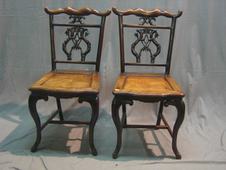 A set of 4 19th Century Oriental Padouk wood bar back dining chairs with pierced shaped backs and solid seats, raised on cabriole supports