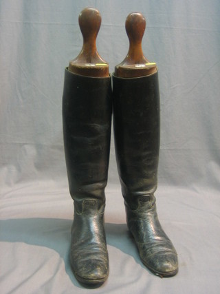 A pair of black leather riding boots with wooden trees by Rigby
