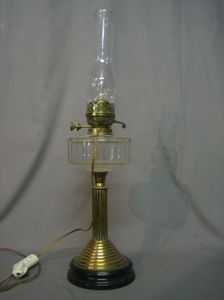 A brass and glass oil lamp converted to a table lamp