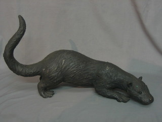 A bronze figure of a walking otter 24"