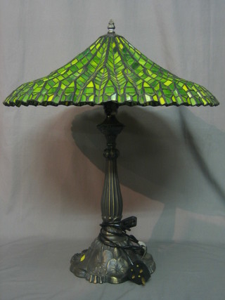 An Art Nouveau style bronze table lamp with green lead glazed shade