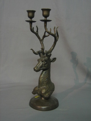 A bronze twin light candelabrum, the base in the form of a stags had