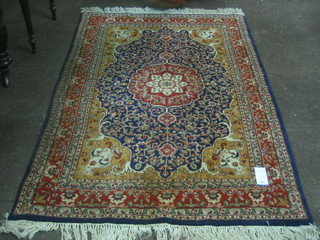 A fine quality blue ground Persian rug with central medallion 71" x 47"