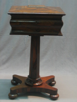 A Victorian rosewood teapoy of cushion form with hinged lid, fitted 2 caddies and 2 recepticals for mixing bowls (no mixing bowls), raised on a chamfered column with triform base 17"
