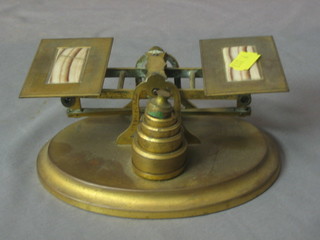 A pair of brass and onyx letter scales