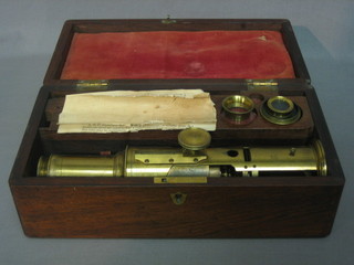 A 19th Century brass single pillar microscope contained in a rosewood box with hinged lid