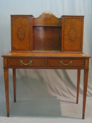 A  handsome Sheraton style inlaid mahogany secretaire bonheur du jour, the raised back fitted a pair of cupboards enclosed by panelled doors, the base fitted 1 long secretaire drawer, raised on square tapering supports ending in spade feet 40"