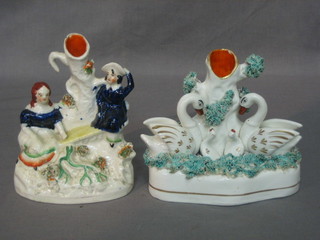 A 19th Century Staffordshire spill vase in the form of swans 5" (slight crack to back) and 1 other decorated a seated couple 6" (f)