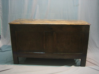 An 18th Century elm coffer with hinged lid, of panelled construction 51"