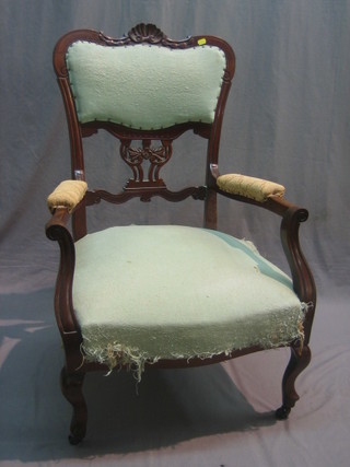 An Edwardian walnut open arm chair with upholstered seat and back, raised on cabriole supports