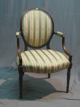 A 19th Century mahogany open arm salon chair, upholstered in Regency stripe material, raised on turned and fluted supports (with old metal repair to back)