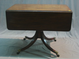 A Victorian mahogany pedestal Pembroke table, raised on a chamfered column with tripod base ending in brass caps and castors 36"