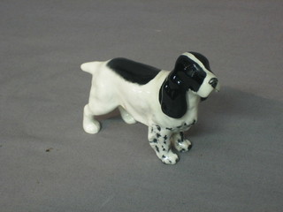 A Beswick figure of a black and white Spaniel 3"