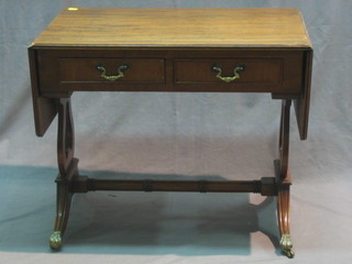 A miniature Georgian style mahogany sofa table fitted 2 long drawers and raised on lyre supports 25"