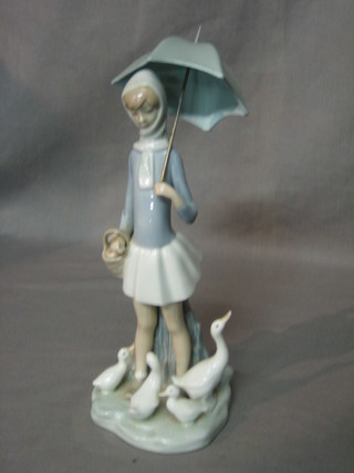 A Lladro figure of a standing girl with parasol and geese, base marked 4510, 10 1/2" (parasol R)