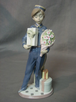 A Lladro figure of a Bell Boy with flowers and parcel, base impressed 5783 11"