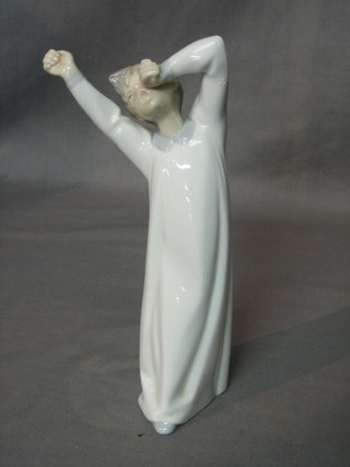 A Lladro figure of a standing yawning boy 9"