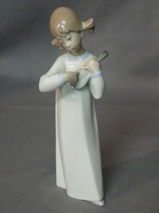 A Lladro figure of a standing girl with guitar 8"