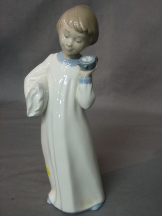 A Nao figure of a standing boy with pillow and alarm clock 10"