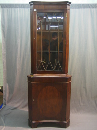 A Georgian style mahogany double corner cabinet with moulded and dentil cornice, the interior fitted adjustable shelves 23"