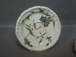 An 18th Century Continental Delft dish with raised reservoir to the centre and floral decoration 9"